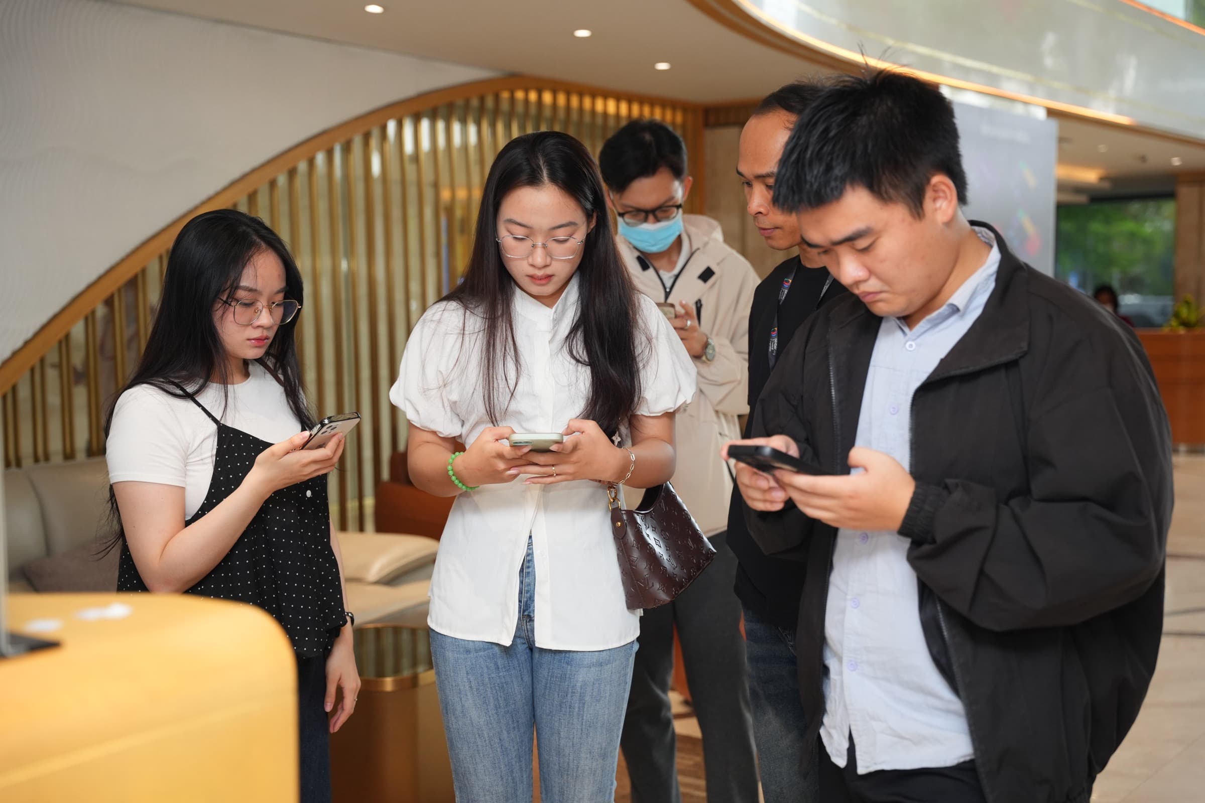 Guests on their phones at a DevDay 2026 talk